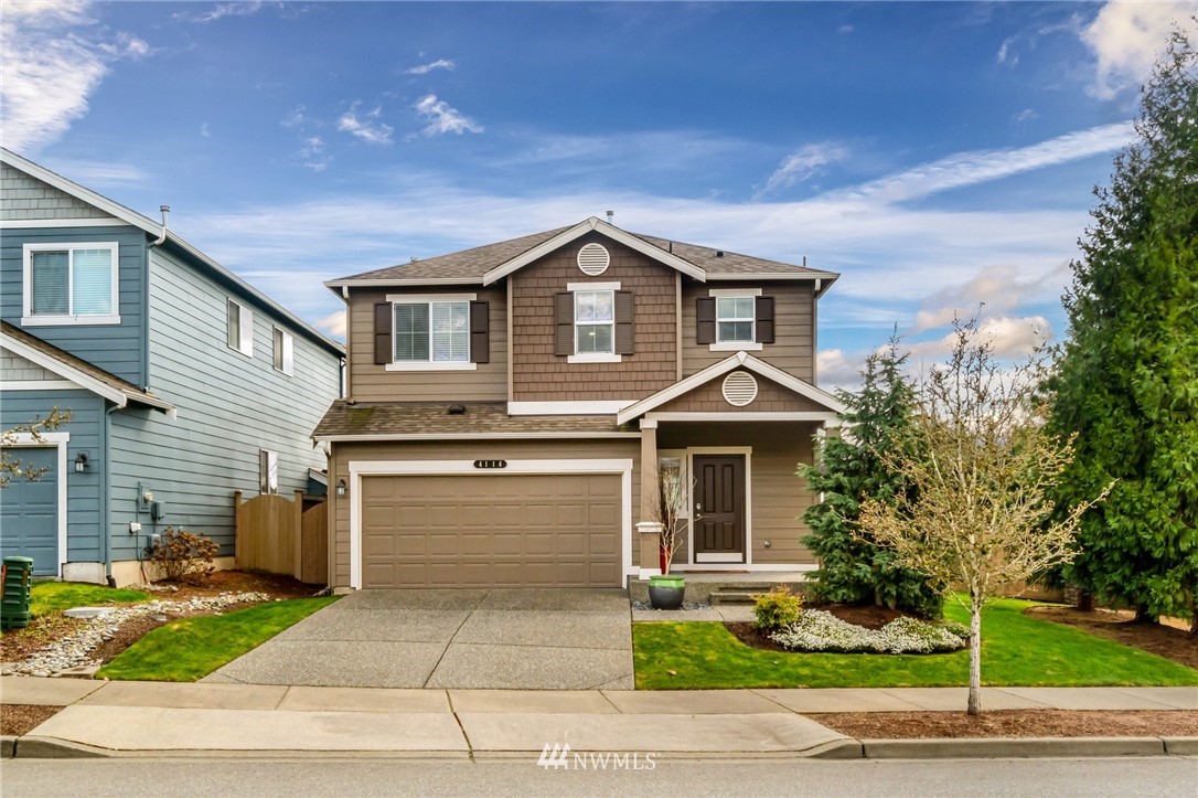 4114 167th Place Southeast Bothell, WA 98012 - Photo 1 of 38 a front view of a house with a yard and garage