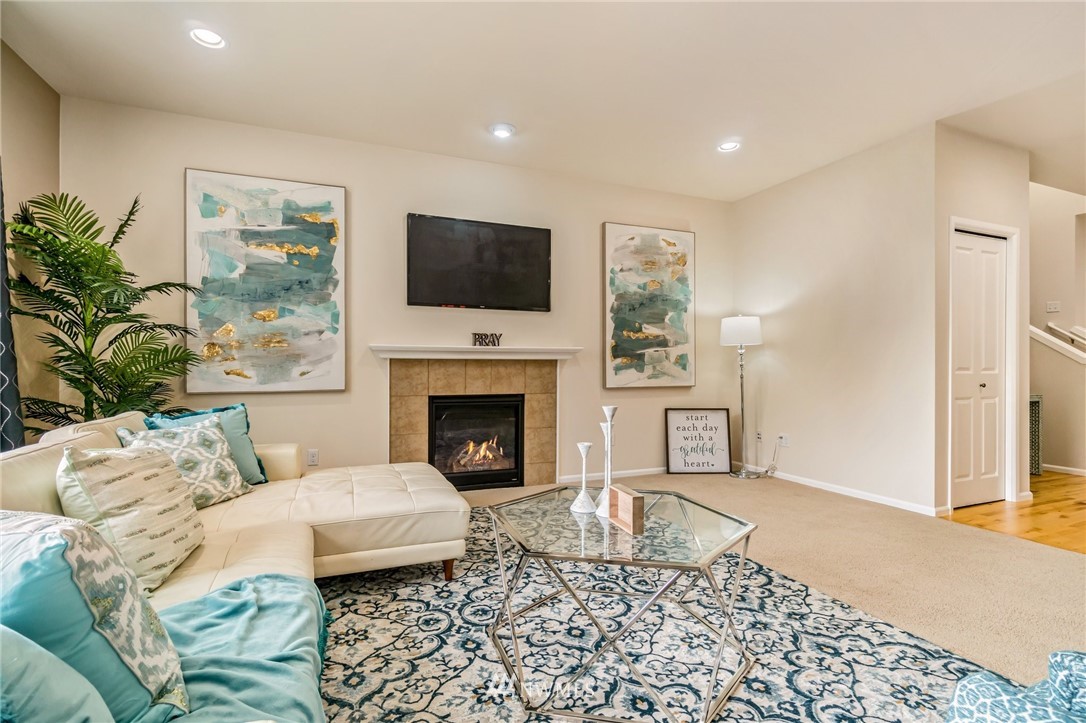 4114 167th Place Southeast Bothell, WA 98012 - Photo 11 of 38 a living room with furniture a flat screen tv and a fireplace