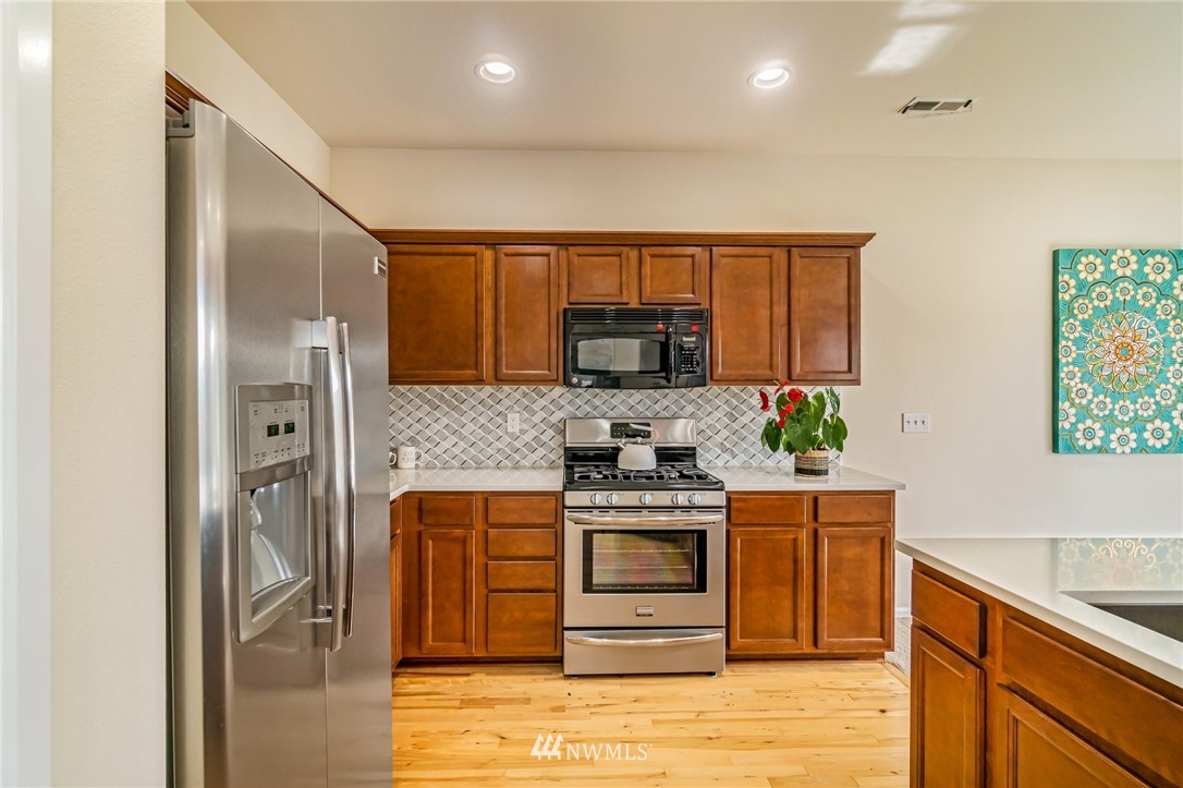 4114 167th Place Southeast Bothell, WA 98012 - Photo 17 of 38 a kitchen with stainless steel appliances granite countertop a stove a sink and a refrigerator