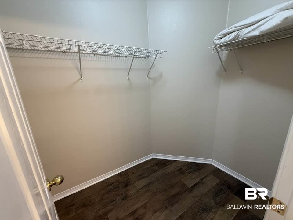 2651 South Juniper Street, Unit 401 Foley, AL 36535 - Photo 23 of 27 Walk in closet featuring dark wood finished floors