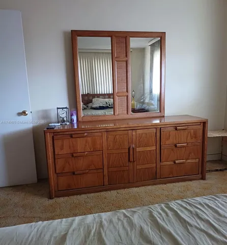 a room with a bed and a mirror