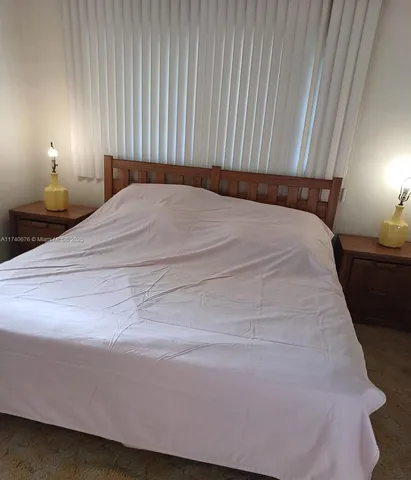 a bedroom with a bed and lamps