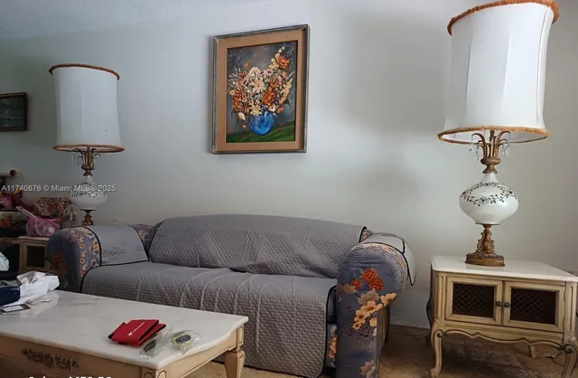 a living room with furniture and a mirror