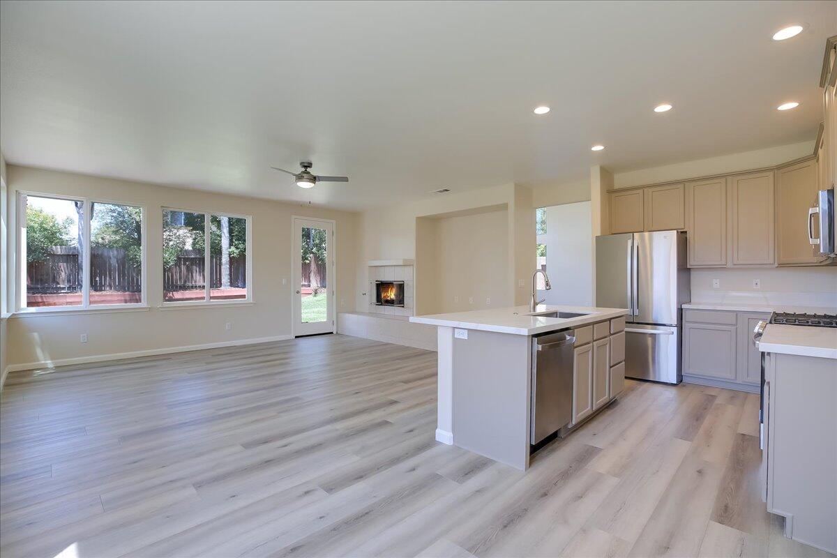 321 Alder Lane Buellton, CA 93427 - Photo 11 of 42 a kitchen with stainless steel appliances granite countertop a stove top oven a sink dishwasher a refrigerator and cabinets with wooden floor