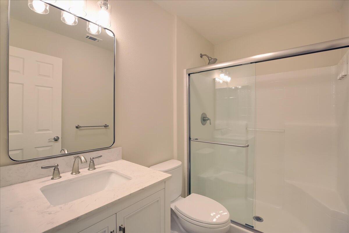 321 Alder Lane Buellton, CA 93427 - Photo 16 of 42 a bathroom with a sink vanity mirror and toilet
