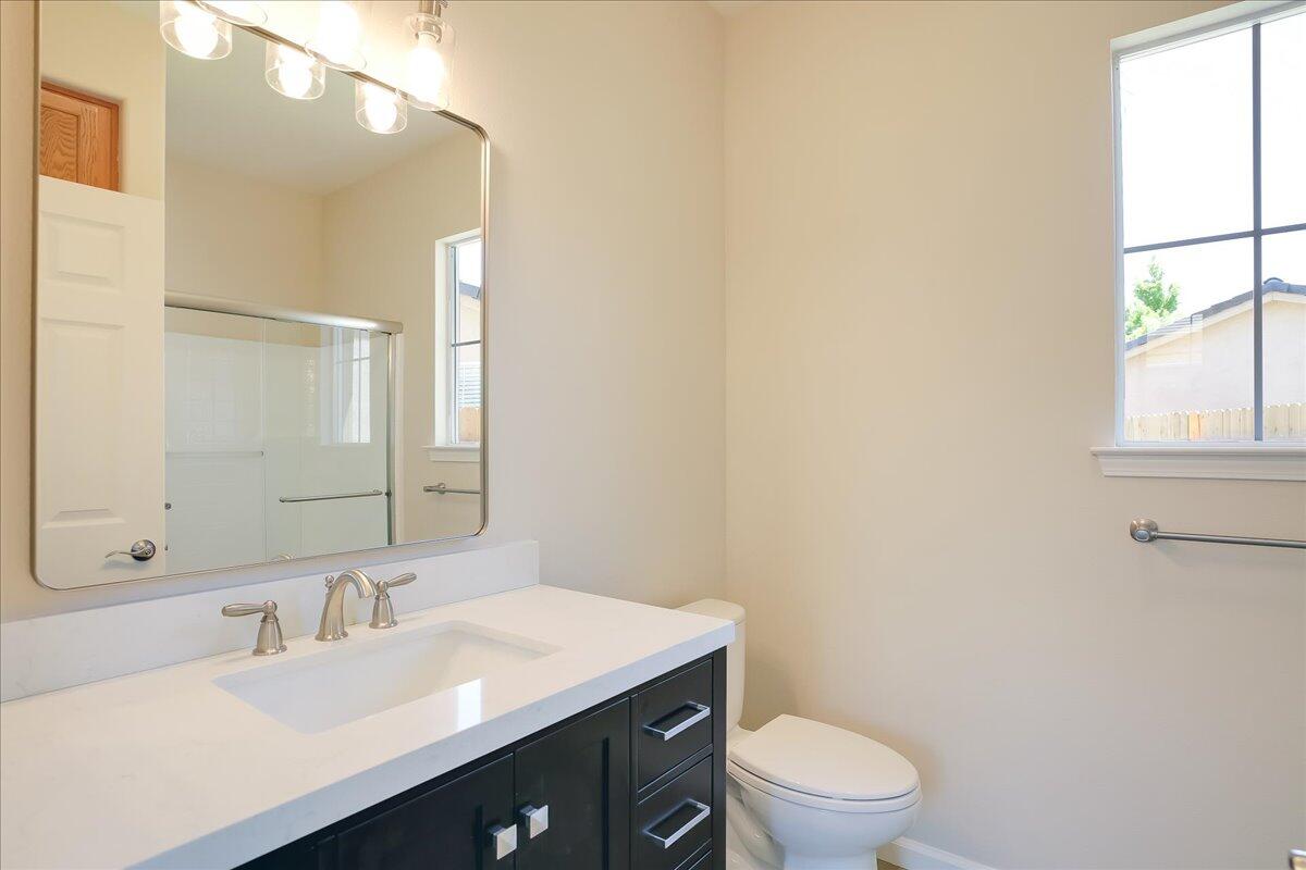 321 Alder Lane Buellton, CA 93427 - Photo 40 of 42 a bathroom with a sink a toilet a mirror and a window