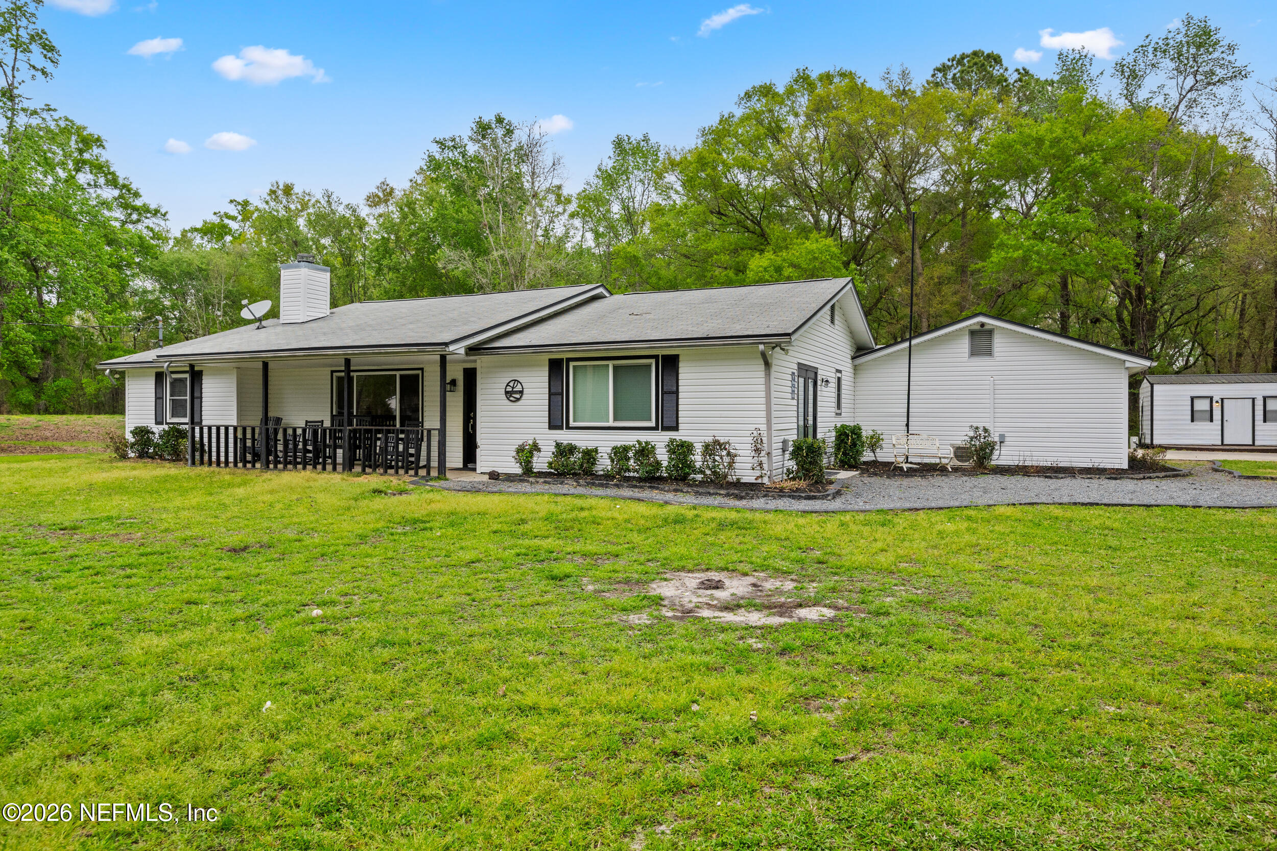 2030 Wayfare Lane Middleburg, FL 32068 - Photo 1 of 46 a view of a white house with a big yard plants and large trees