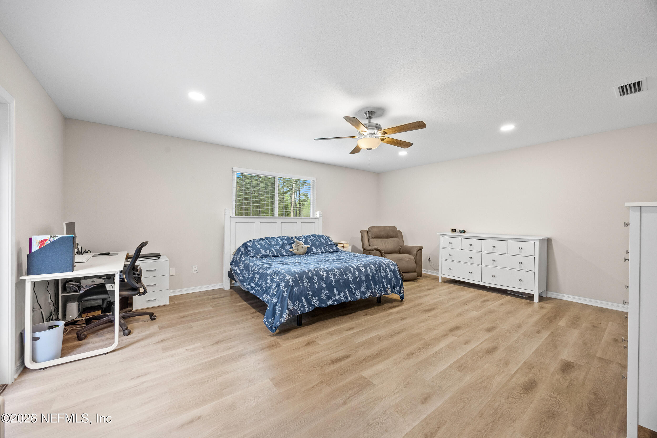 2030 Wayfare Lane Middleburg, FL 32068 - Photo 13 of 46 a bedroom with a bed and a table in it