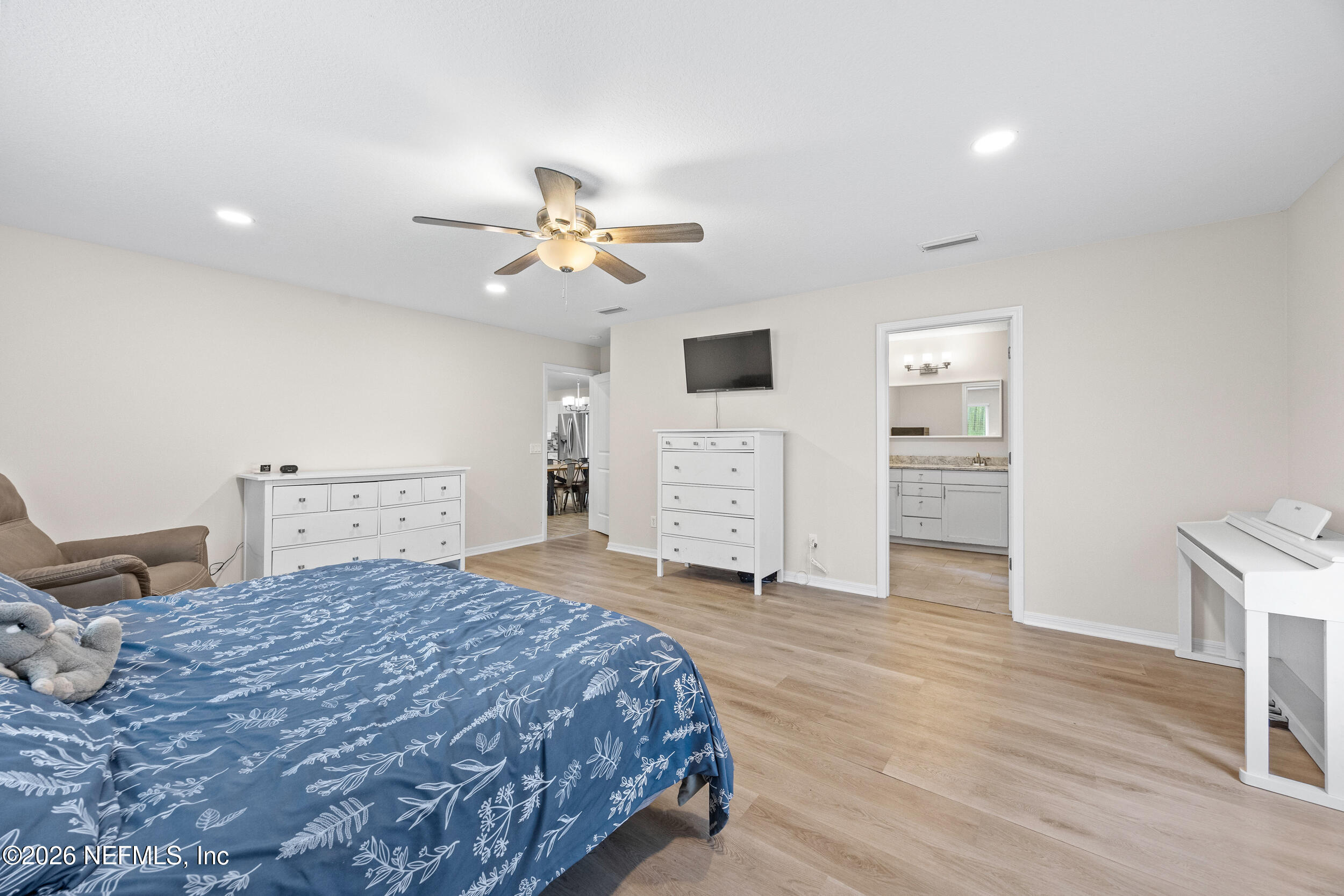 2030 Wayfare Lane Middleburg, FL 32068 - Photo 14 of 46 a spacious bedroom with a bed and a desk