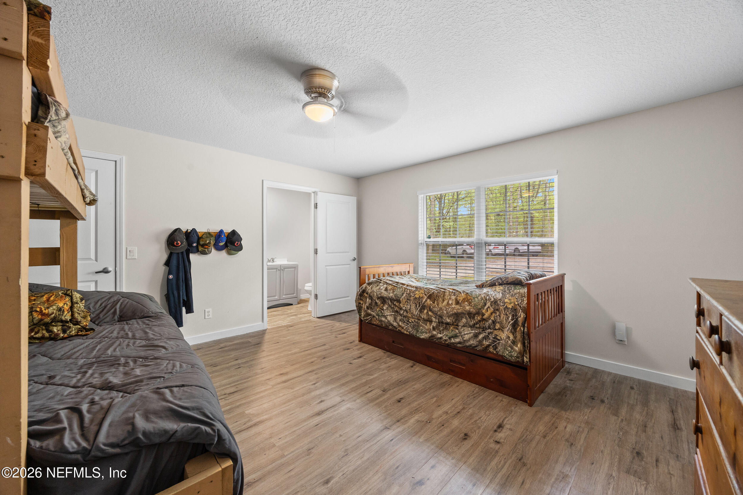 2030 Wayfare Lane Middleburg, FL 32068 - Photo 21 of 46 a bedroom with a bed and wooden floor