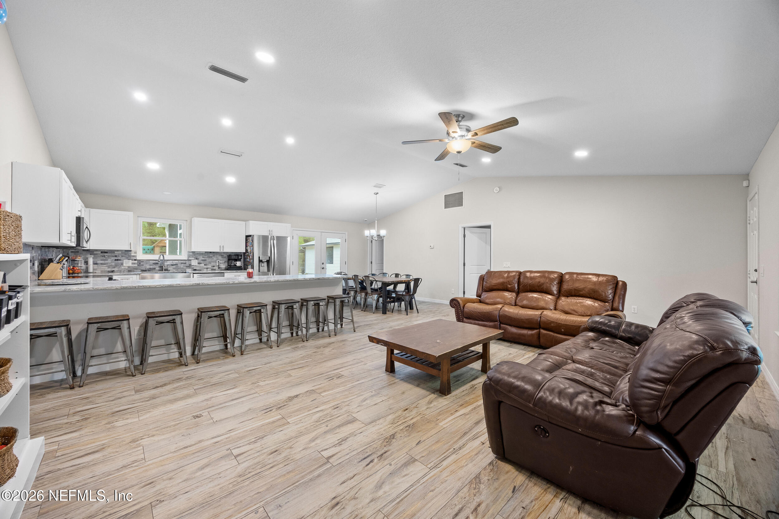 2030 Wayfare Lane Middleburg, FL 32068 - Photo 8 of 46 a living room with furniture stairs and a chandelier