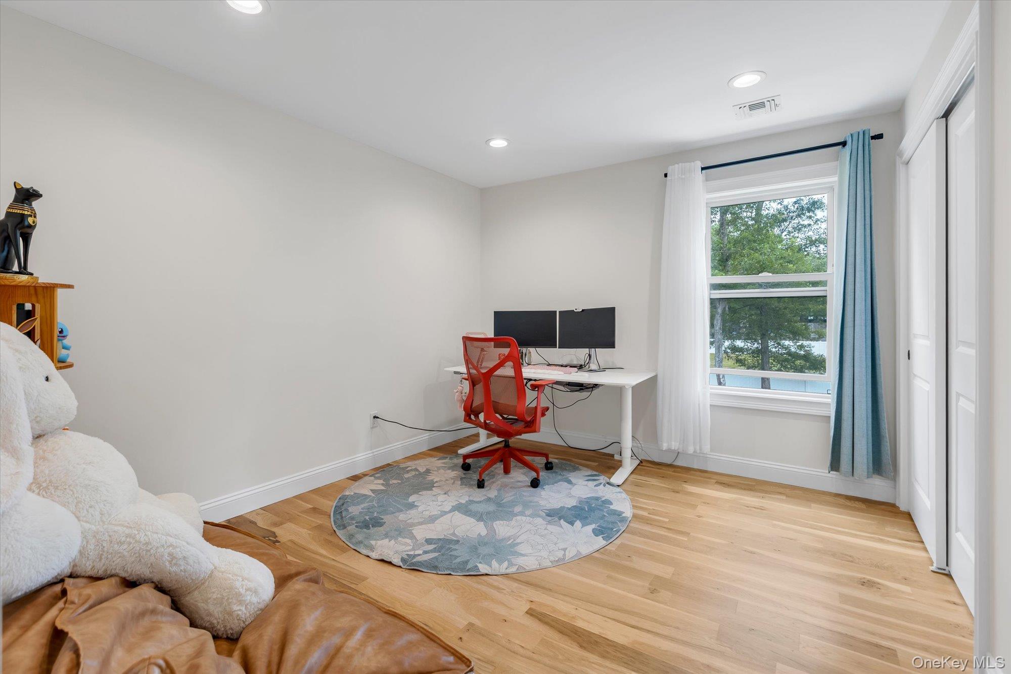135 Elizabeth Way Ridge, NY 11961 - Photo 15 of 24 a room with furniture and a window