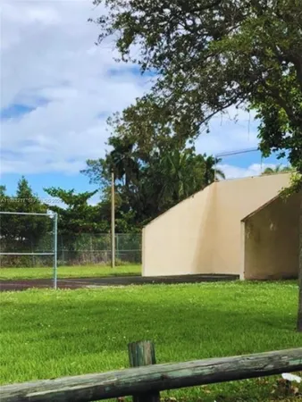 a view of a backyard with swimming pool