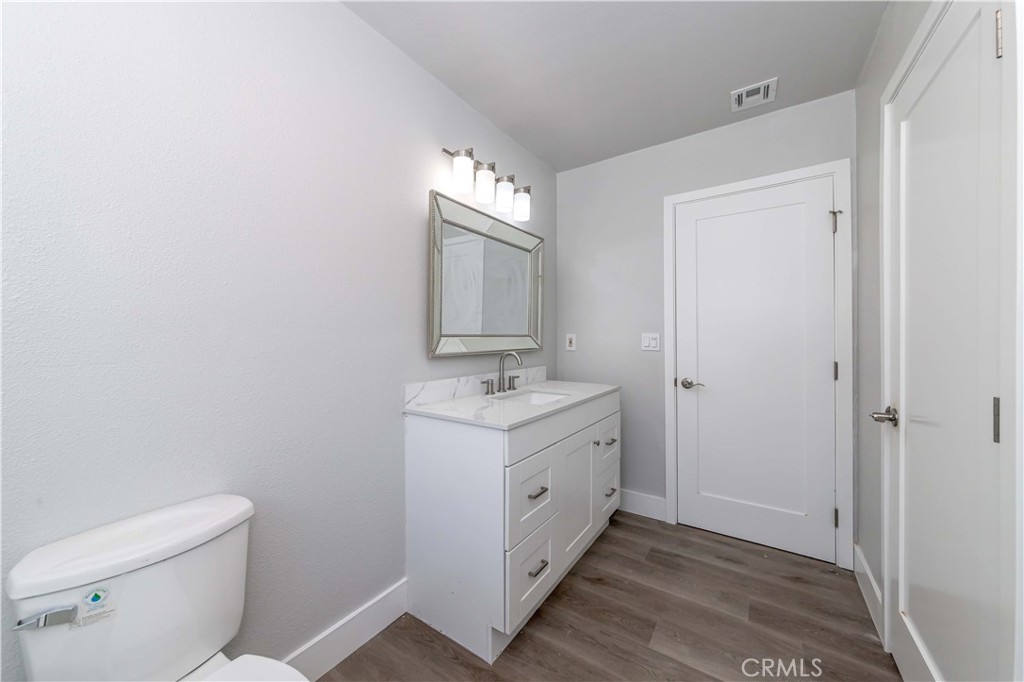 4569 Whitney Drive El Monte, CA 91731 - Photo 11 of 41 a bathroom with a sink a toilet and mirror