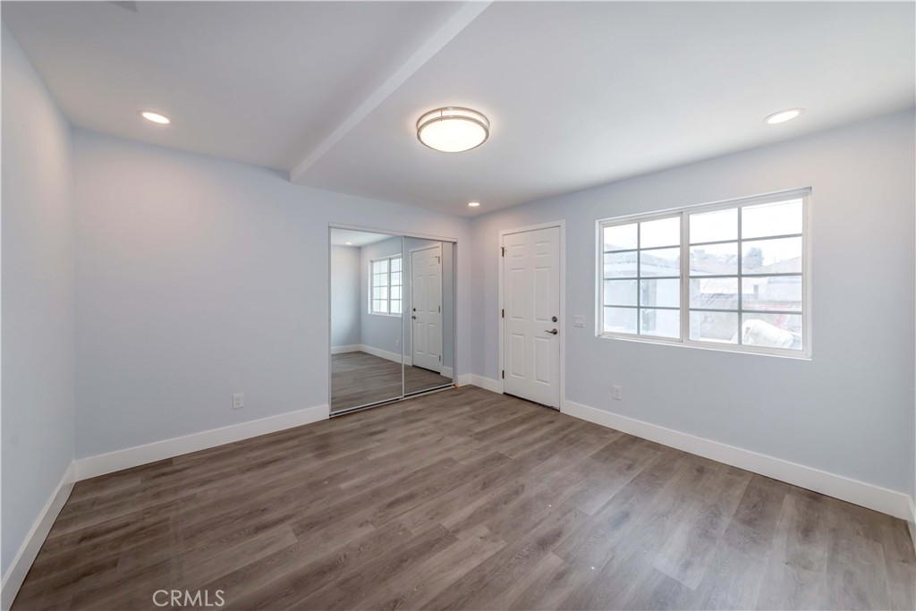 4569 Whitney Drive El Monte, CA 91731 - Photo 12 of 41 an empty room with wooden floor and windows