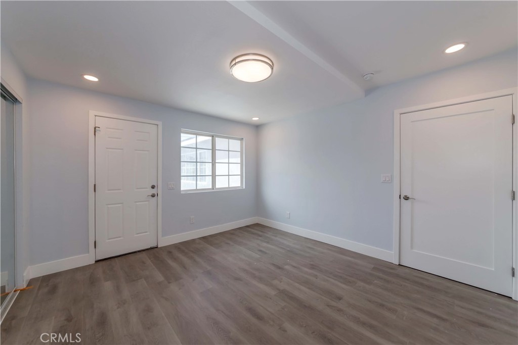 4569 Whitney Drive El Monte, CA 91731 - Photo 13 of 41 an empty room with wooden floor and windows