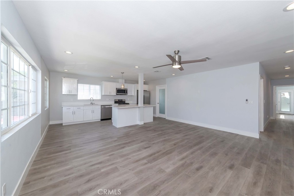 4569 Whitney Drive El Monte, CA 91731 - Photo 17 of 41 an empty room with wooden floor kitchen view and a window