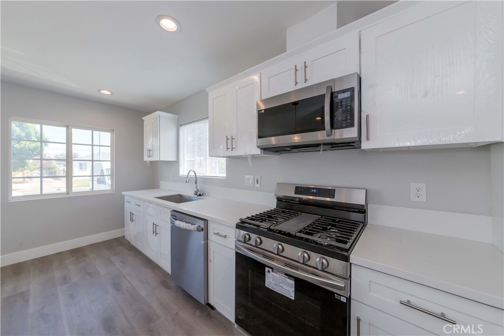 4569 Whitney Drive El Monte, CA 91731 - Photo 22 of 41 a kitchen with stainless steel appliances a sink a stove and microwave