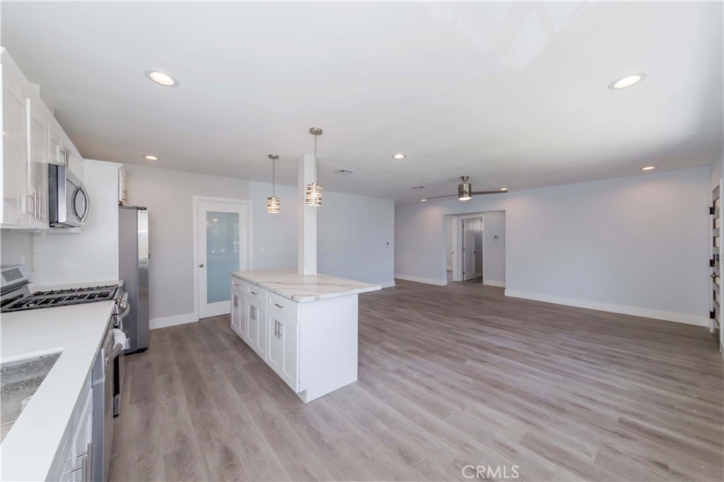 4569 Whitney Drive El Monte, CA 91731 - Photo 23 of 41 a large kitchen with a lot of counter space and wooden floor