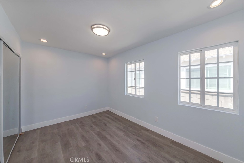 4569 Whitney Drive El Monte, CA 91731 - Photo 24 of 41 an empty room with wooden floor and windows