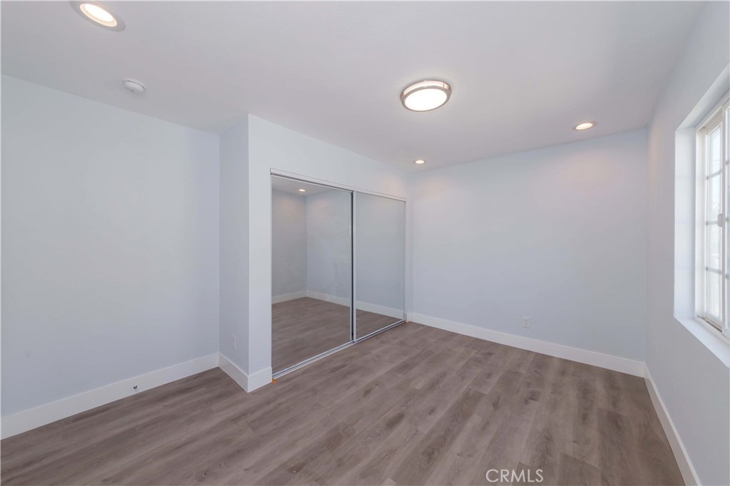 4569 Whitney Drive El Monte, CA 91731 - Photo 25 of 41 an empty room with wooden floor and windows