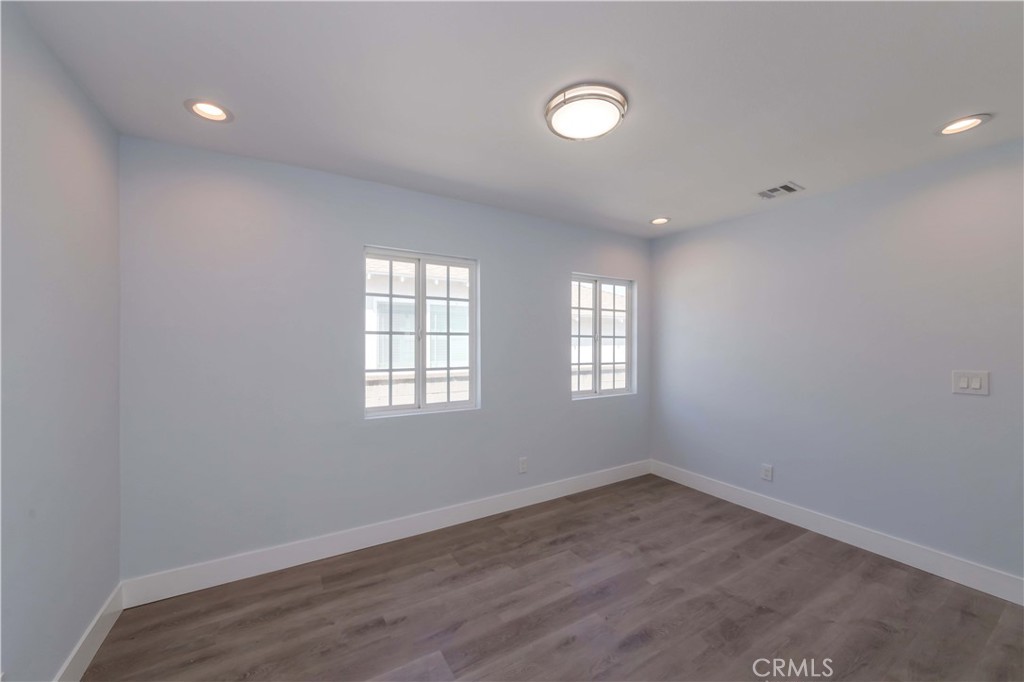 4569 Whitney Drive El Monte, CA 91731 - Photo 26 of 41 an empty room with wooden floor and windows