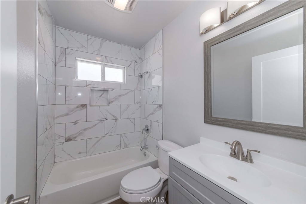 4569 Whitney Drive El Monte, CA 91731 - Photo 27 of 41 a bathroom with a bathtub shower sink vanity mirror and toilet