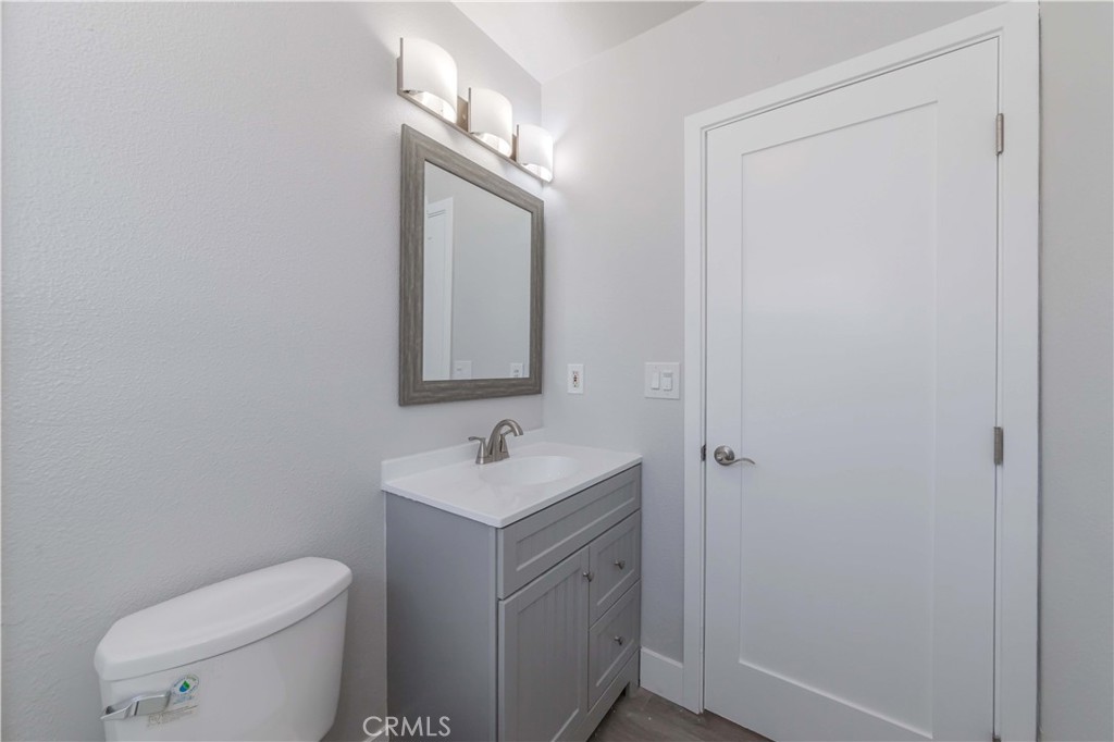 4569 Whitney Drive El Monte, CA 91731 - Photo 28 of 41 a bathroom with a toilet a sink and mirror