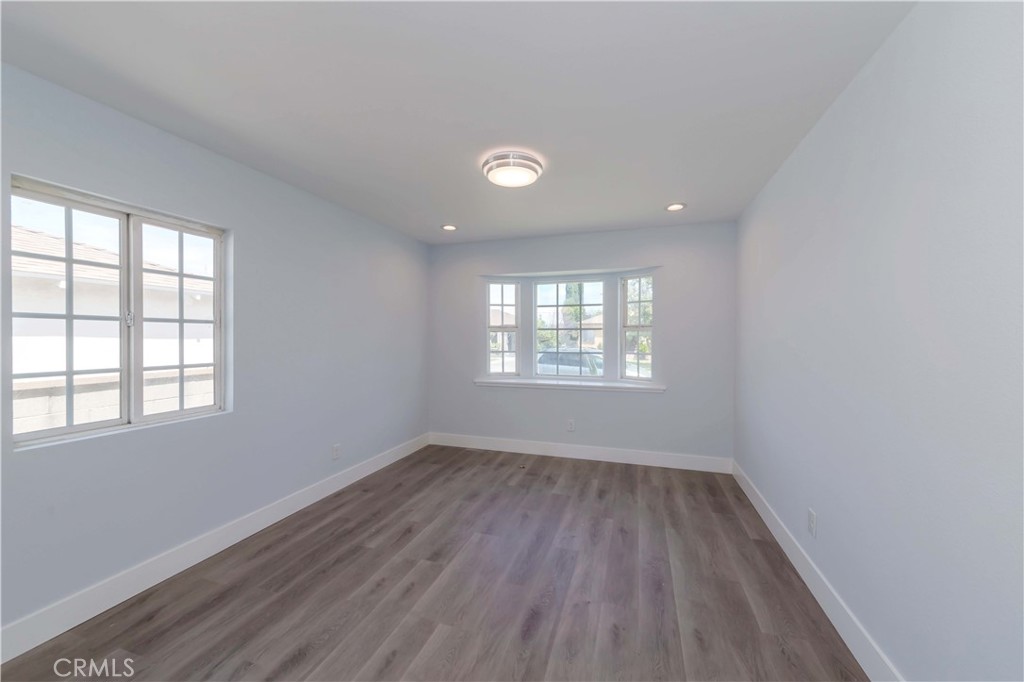 4569 Whitney Drive El Monte, CA 91731 - Photo 29 of 41 an empty room with wooden floor and windows