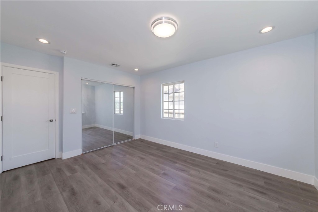 4569 Whitney Drive El Monte, CA 91731 - Photo 30 of 41 an empty room with wooden floor and windows