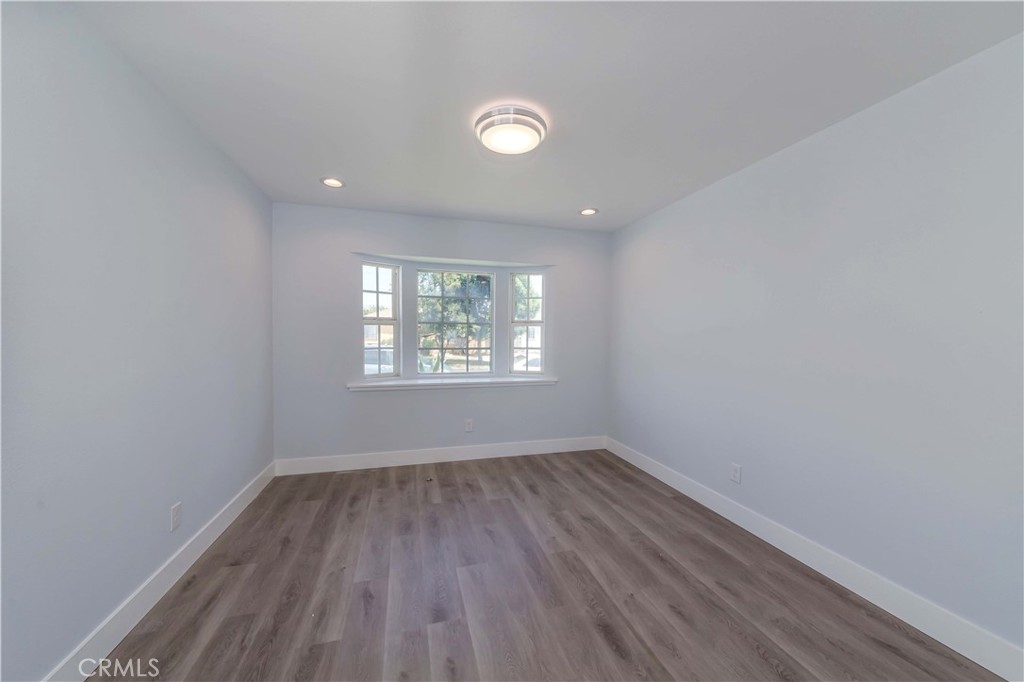 4569 Whitney Drive El Monte, CA 91731 - Photo 31 of 41 an empty room with wooden floor and windows
