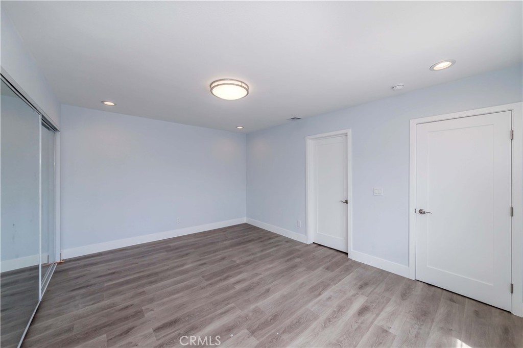 4569 Whitney Drive El Monte, CA 91731 - Photo 8 of 41 an empty room with wooden floor and windows