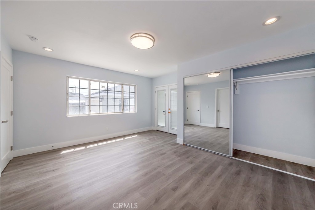4569 Whitney Drive El Monte, CA 91731 - Photo 9 of 41 an empty room with wooden floor and windows