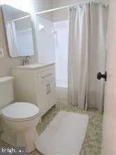 a bathroom with a toilet a sink and shower