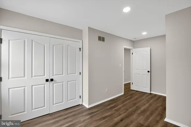 an empty room with wooden floor