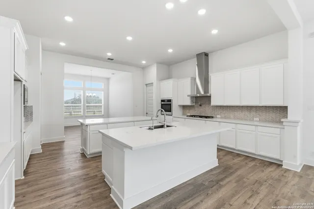 a kitchen with a sink stove and cabinets