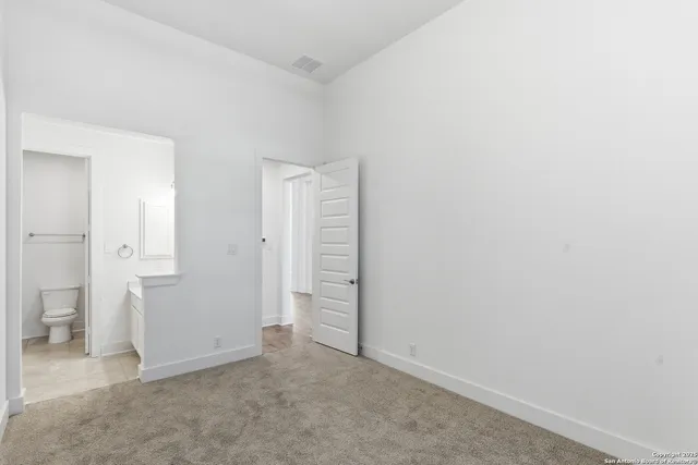 an empty room with an entrance to other room