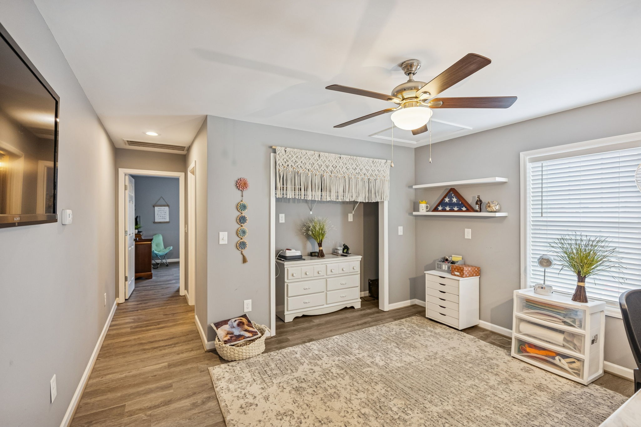 403 Bland Road Estill Springs, TN 37330 - Photo 29 of 66 a view of a livingroom with wooden floor and a ceiling fan