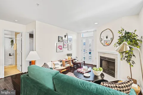 a living room with furniture a fireplace and a window