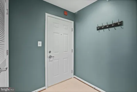 a view of a hallway with wooden floor windows