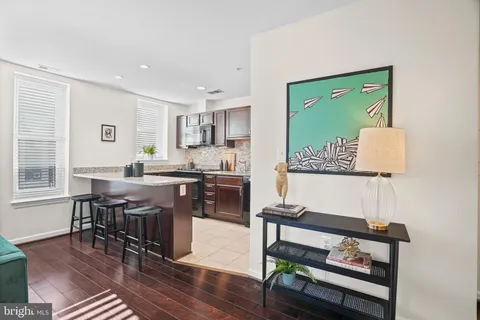 a kitchen with sink and refrigerator