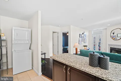 a living room with furniture a fireplace and a large window