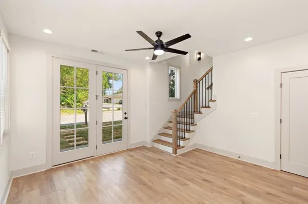 wooden floor in an empty room with a window