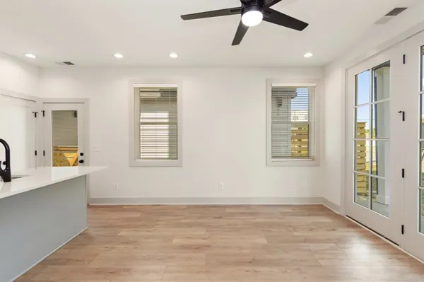 a view of an empty room with window and cabinet