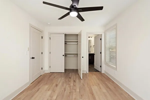 a view of empty room with wooden floor