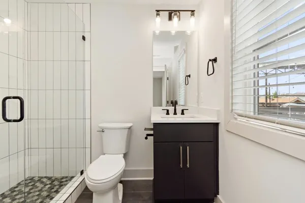 a bathroom with a sink toilet and shower