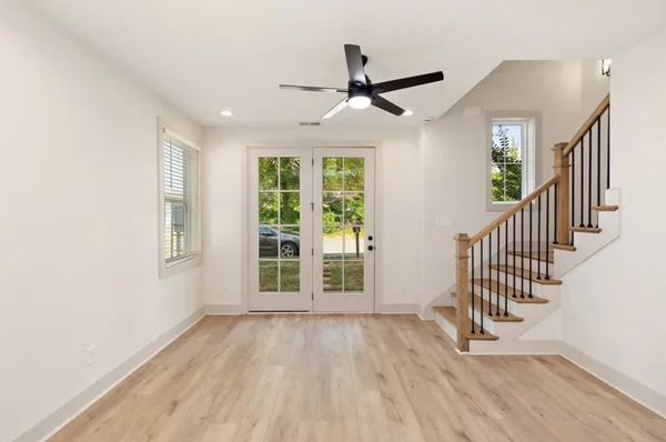 wooden floor in an empty room with a window