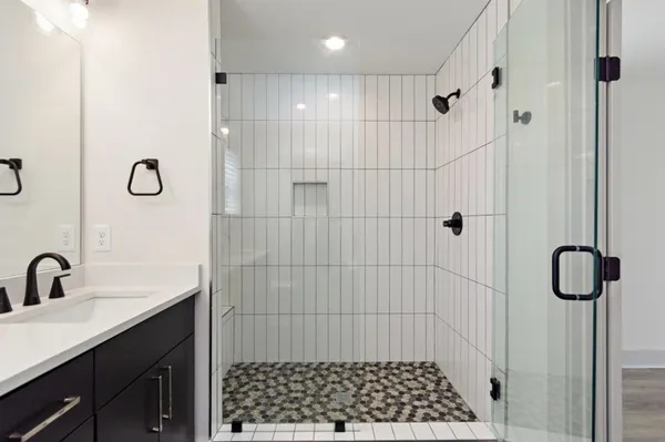 a bathroom with a shower and a sink
