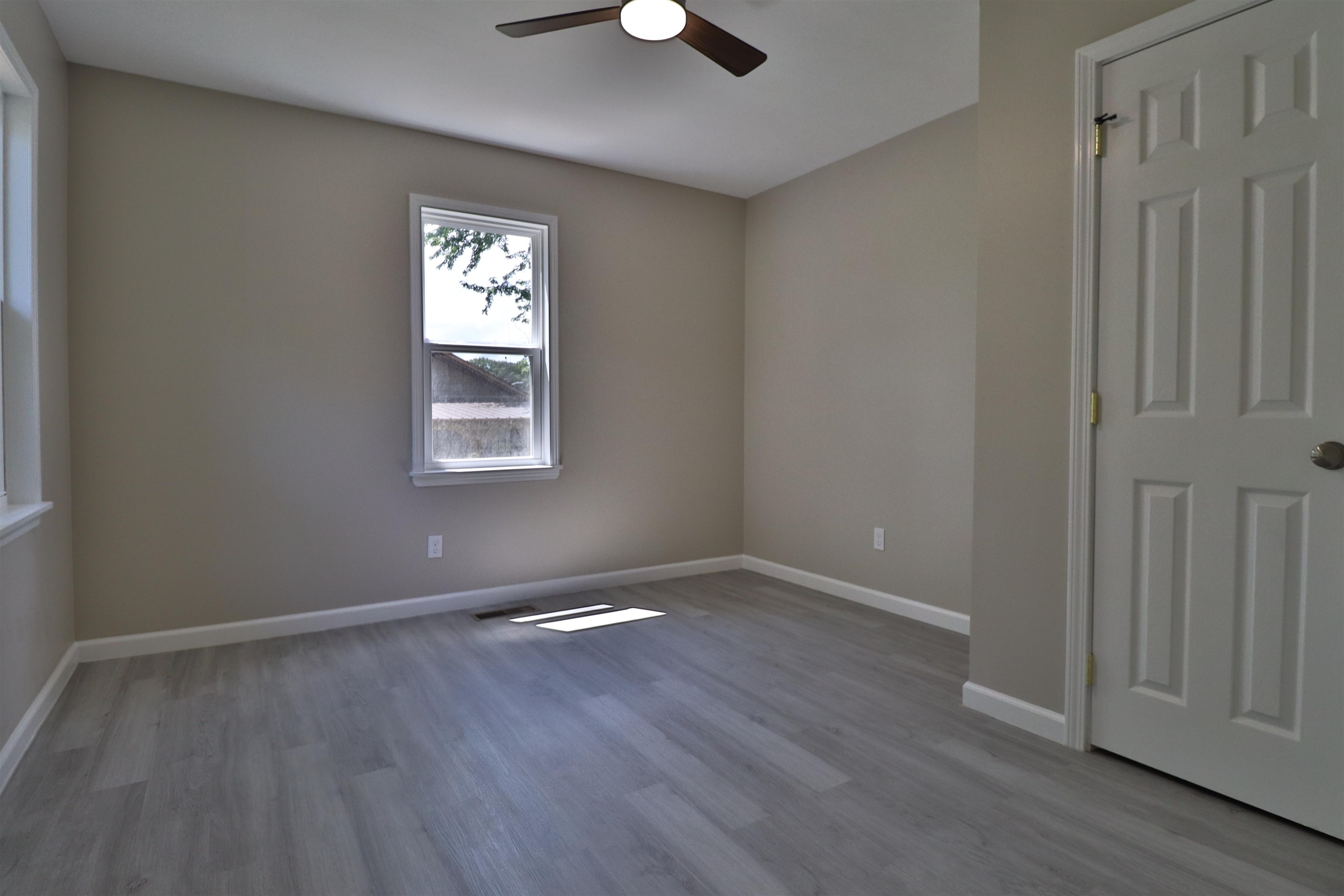 224 Kellar Avenue Ripley, TN 38063 - Photo 17 of 30 an empty room with wooden floor and windows