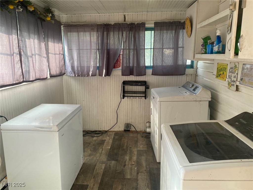 1001 Mill Street Ely, NV 89301 - Photo 15 of 18 Laundry area with washer and clothes dryer and wood-type flooring